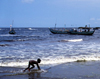 Grand Bassa County, Liberia, West Africa: Buchanan - incipient surfer on the beach - photo by M.Sturges