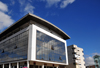 Antananarivo / Tananarive / Tana - Analamanga region, Madagascar: commercial building on Ho Chi Mihn square - photo by M.Torres