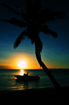 Vohilava, le Sainte Marie / Nosy Boraha, Analanjirofo region, Toamasina province, Madagascar: beach sunset - coconut tree and boat - photo by M.Torres