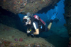 Malaysia - underwater image - Perhentian Island: diver entering a cave - scuba diving (photo by Jez Tryner)