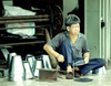 Malaysia - Sarawak - Kuching (Borneo): a Chinese tradesman makes sheetmetal objects on the street (photo by Rod Eime)