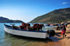 Cape Maclear / Chembe, Malawi: boat carrying two hand carved pirogues is prepared for a night of fishing - wooden dugout canoes stacked across the gunnels - cape on the right, Domwe Island on the left - photo by M.Torres