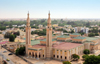 Nouakchott, Mauritania: the Saudi Mosque aka Grand Mosque, seen from above, with the city's skyline in the background - King Faisal avenue and Mamadou Konate street - la Mosque Saoudienne - photo by M.Torres