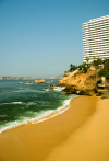Acapulco de Jurez, Guerrero, Mexico:sandy beach Acapulco and hotel on a cliff - photo by D.Smith