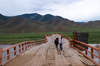 Khvsgl province, Mongolia: young boy leading his horse on an old bridge, on the way to Mrn - photo by A.Ferrari