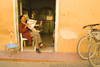 Taroudant, Morocco: shopkeeper reading newspaper - no customers, no problem - photo by Sandia