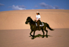 Mozambique / Moambique - Bazaruto: woman horse riding on the sand dunes / passeio a cavalo nas dunas - photo by F.Rigaud