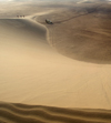 Namibia: Sand dune scenic with people and land rover, Skeleton Coast - photo by B.Cain