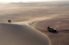 Namibia: sand dune scenic, people, land rover, Skeleton Coast - photo by B.Cain