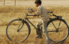 Kathmandu, Nepal: child riding an adult bicycle - photo by E.Petitalot
