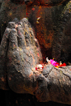 Kathmandu, Nepal: hands of stone statue with flower offerings - photo by J.Pemberton