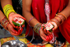 Kathmandu, Nepal: women holding offerings for puja - photo by J.Pemberton