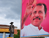 Managua, Nicaragua: small statue of Sandino and giant poster of Daniel Ortega Saavedra at the Presidential Palace - Casa Presidencial - Plaza de la Revolucin / Plaza de la Repblica - photo by M.Torres