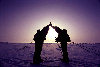 North Pole: celebrating a successful expedition - silhouettes and sun in the North Pole - two skiers - Severn pl, Nordpolen,Polo Norte, Ple Nord, Polo Nord, Noordpool, Polul Nord (photo by Eric Philips)