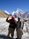 Pakistan - Baltoro Muztagh subrange - Karakoram mountains - Himalayan range - Northern Areas: Balti porters with K2 and Broad peak - victory sign - photo by A.Summers