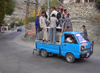 Karimabad / Baltit - Northern Areas, Pakistan: riding is better than walking - crowded Chinese made pick-up truck - Hunza Valley - KKH - photo by D.Steppuhn