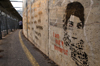 Bethlehem, West Bank, Palestine: graffitti on wall outside checkpoint - Palestinian woman's face and caption 'I am not a terrorist' - photo by J.Pemberton