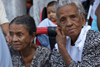 Two old ladies in traditional mourning clothes watch the dances at the  meeting of congos and devils, Portobello, Coln, Panama, Central America - photo by H.Olarte