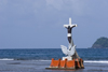 a crucifix in the water. Isla Grande, Coln, Panama, Central America - photo by H.Olarte