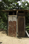 Capira, Panama province: man looking out from an outhouse - basic restroom - photo by H.Olarte