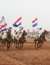 Luque, Departamento Central, Paraguay: horse riders with Paraguayan flags - photo by A.Chang