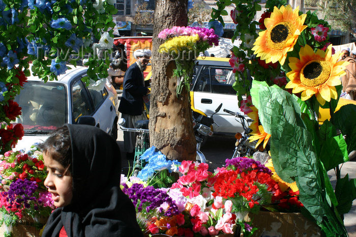 afghanistan8: Afghanistan - Herat - girl passing a shop selling artificial flowers - photo by E.Andersen - (c) Travel-Images.com - Stock Photography agency - Image Bank