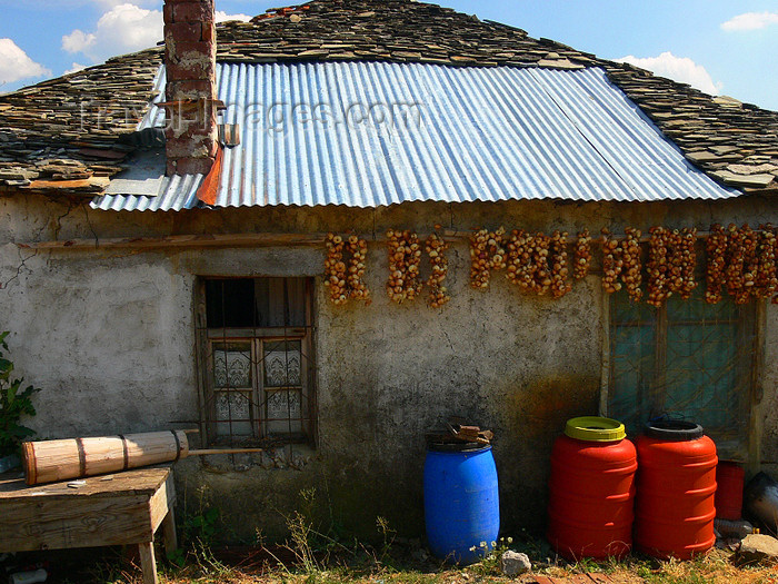 albania161: Kamnik, Kolonjë, Korçë county, Albania: rural house with onion braids and half stone half metal roof - photo by J.Kaman - (c) Travel-Images.com - Stock Photography agency - Image Bank