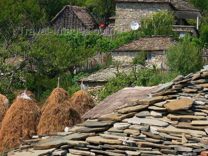 albania164: Kamnik, Kolonjë, Korçë county, Albania: schist roof and haystacks - rural scene - photo by J.Kaman - (c) Travel-Images.com - Stock Photography agency - Image Bank