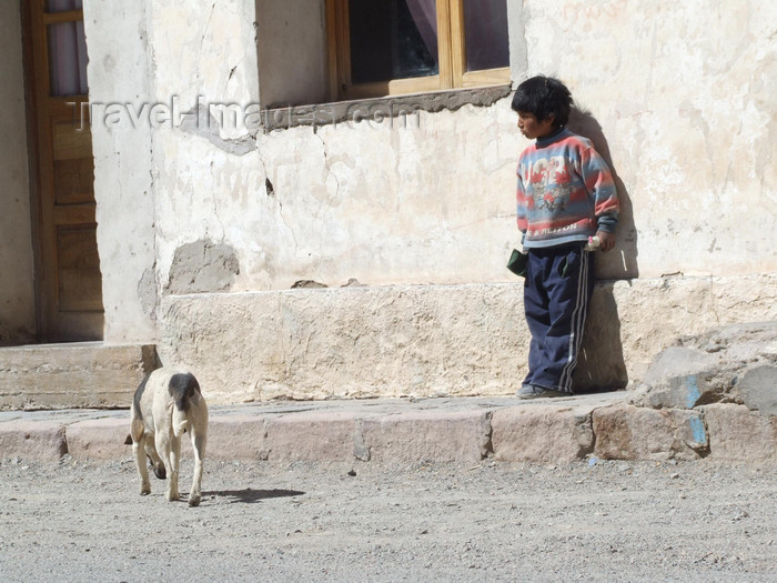 argentina292: Argentina - Salta province - San Antonio de los Cobres - boy and dog - route of the Tren de las Nubes - Train of the Clouds - images of South America by M.Bergsma - (c) Travel-Images.com - Stock Photography agency - Image Bank