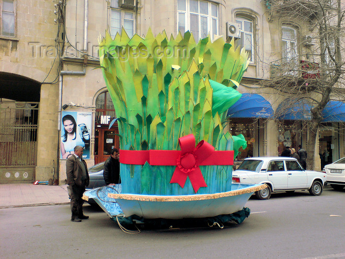 azer168: Baku, Azerbaijan: Novruz decoration in the city - a man looks at a giant Semeni, sprouting wheat - street scene - photo by N.Mahmudova - (c) Travel-Images.com - Stock Photography agency - Image Bank