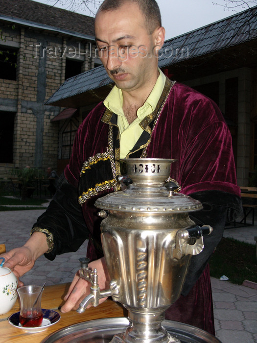 azer436: Sheki / Shaki - Azerbaijan: man in Caucasian garb serves tea - samovar - photo by N.Mahmudova - (c) Travel-Images.com - Stock Photography agency - Image Bank