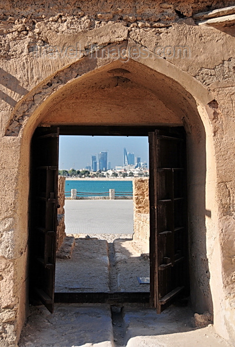 bahrain2: Arad, Muharraq Island, Bahrain: Arad Fort - view of the Al Manama skyline through the fort's main gate - photo by M.Torres - (c) Travel-Images.com - Stock Photography agency - Image Bank