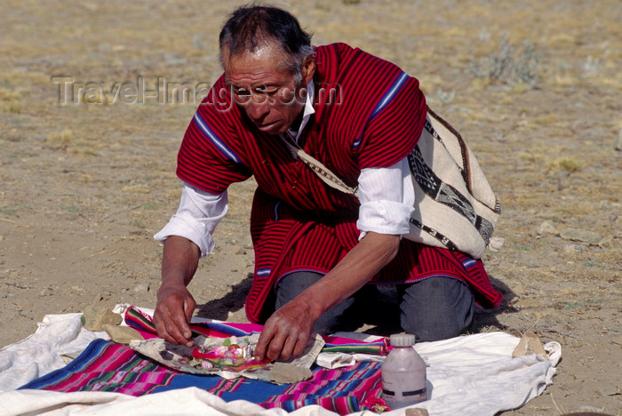 bolivia150: Isla del Sol, Lake Titicaca, Manco Kapac Province, La Paz Department, Bolivia: a kallawayas (shaman) performs a koada (offering) to Pancha Mama (Mother Earth) - photo by C.Lovell - (c) Travel-Images.com - Stock Photography agency - Image Bank