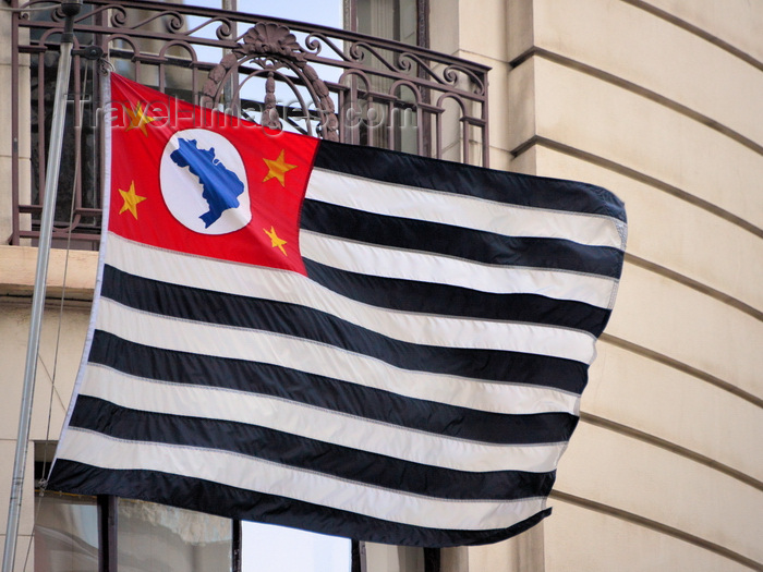 brazil482: São Paulo, Brazil: São Paulo flag flying in a downtown building - composed of 13 horizontal black and white stripes, on a red canton, a silhouette map of Brazil appears in blue on a white circle, a small yellow star appears in each corner of the canton - photo by M.Torres - (c) Travel-Images.com - Stock Photography agency - Image Bank