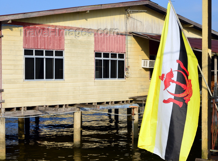 brunei140: Bandar Seri Begawan, Brunei Darussalam: flag of Brunei and wooden building on stilts at Kampong Pg Tajuddin Hitam water village - photo by M.Torres - (c) Travel-Images.com - Stock Photography agency - Image Bank