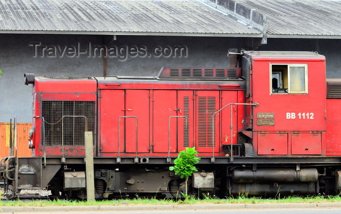 cameroon54: Cameroon, Douala: Alsthom locomotive on the railway line serving Douala harbour, with port warehouses in the background - Boulevard du Général Leclerc 27 Août 1940 - Douala harbor handles most of the country's imports and export  - photo by M.Torres - (c) Travel-Images.com - Stock Photography agency - Image Bank