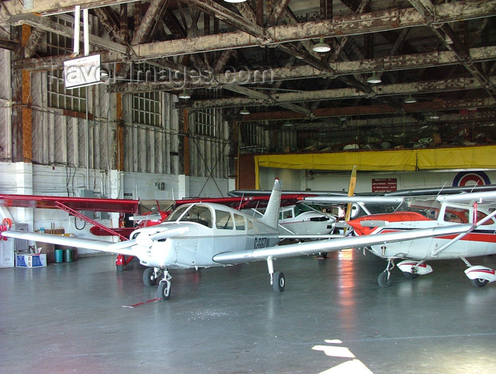 canada152: Welland, Ontario, Canada / Kanada: light aircraft in an hangar - Piper PA-28-151 Cherokee Warrior - C-GGZW - Welland Aero Center - civil aviation - photo by R.Grove - (c) Travel-Images.com - Stock Photography agency - Image Bank