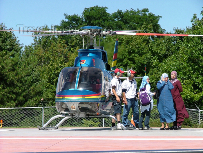 canada162: Niagara Falls, Ontario, Canada / Kanada: veiled women and Niagara Helicopters Bell 407 - helicopter rides around the Niagara falls - photo by R.Grove - (c) Travel-Images.com - Stock Photography agency - Image Bank