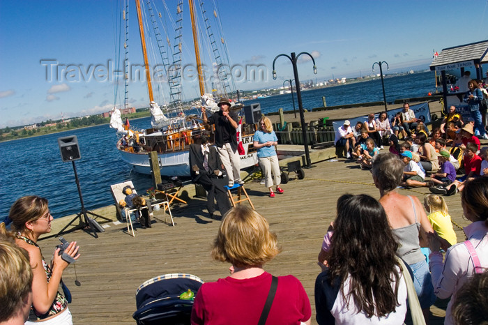 canada440: Tourists watching street buskers at the hirtoric waterfront pier in Halifax, Noca, Scotia, Canada - photo by D.Smith - (c) Travel-Images.com - Stock Photography agency - Image Bank