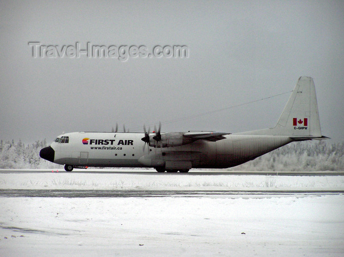 canada523: Northwest Territories, Canada: four engined Hercules aeroplane waits on snowy tarmac - First Air Lockheed L-100-30 Hercules - C-GHPW (cn 4799) - photo by Air West Coast - (c) Travel-Images.com - Stock Photography agency - Image Bank