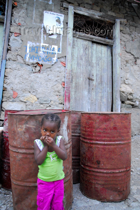 capeverde81: Fajã de Água, Brava island - Cape Verde / Cabo Verde: young girl and old fuel barrels - photo by E.Petitalot - (c) Travel-Images.com - Stock Photography agency - Image Bank