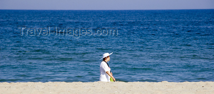 catalon135: La Pineda, Vila-seca, Costa Dorada, Tarragona, Catalonia: a woman with a large hat walks along the beach - photo by B.Henry - (c) Travel-Images.com - Stock Photography agency - Image Bank