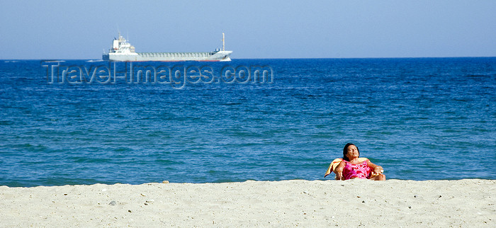 catalon137: La Pineda, Vila-seca, Costa Dorada, Tarragona, Catalonia: woman on a deck chair and a passing freighter - photo by B.Henry - (c) Travel-Images.com - Stock Photography agency - Image Bank