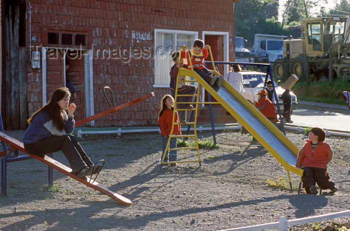 chile198: Chonchi, Chiloé island, Los Lagos Region, Chile: children play on a slide - house with roof shingle covered walls - photo by C.Lovell - (c) Travel-Images.com - Stock Photography agency - Image Bank