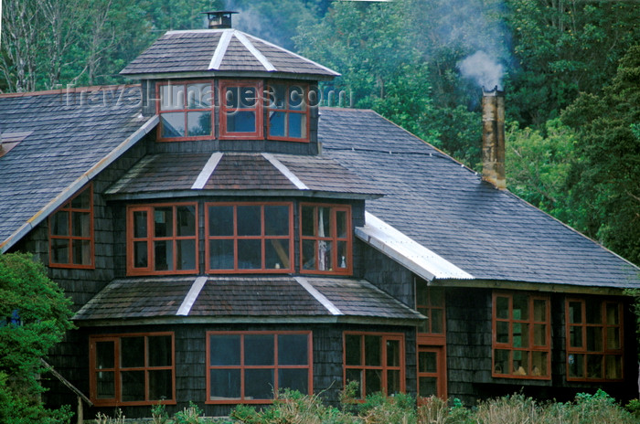 chile225: Anihue Bay, Aisén region, Chile: wooden home with walls covered in wooden shingles – smoking chimney - temperate rain forest in northern Patagonia west of La Junta - photo by C.Lovell - (c) Travel-Images.com - Stock Photography agency - Image Bank