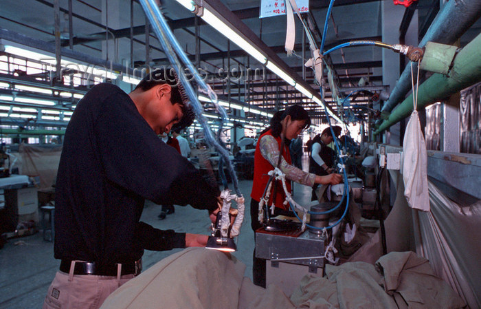 china245: Dongguan, Guangdong province, China: ironing - Chinese factory workers - clothes factory - photo by B.Henry - (c) Travel-Images.com - Stock Photography agency - Image Bank