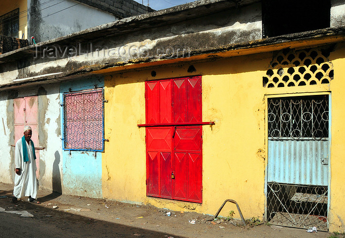 comoros65: Moroni, Grande Comore / Ngazidja, Comoros islands: colourful façade and man wearing a kanzu white robe - photo by M.Torres - (c) Travel-Images.com - Stock Photography agency - Image Bank