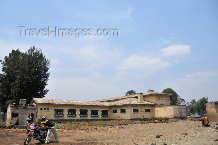 congo-dr21: Goma, Nord-Kivu, Democratic Republic of the Congo: biker in front of an old colonial school building - photo by M.Torres - (c) Travel-Images.com - Stock Photography agency - Image Bank