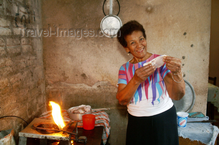 cuba48: Cuba - Guardalavaca - shy aunt cooking fish - photo by G.Friedman - (c) Travel-Images.com - Stock Photography agency - Image Bank