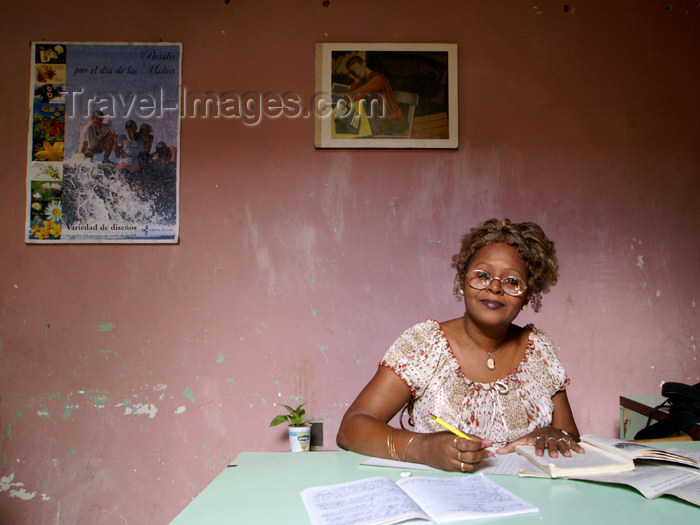 cuba79: Cuba - Holguín - secretary and red wall - an office worker studies at her desk - photo by G.Friedman - (c) Travel-Images.com - Stock Photography agency - Image Bank